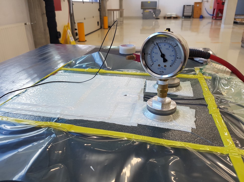Vacuum processes using porous bleeder and filter cloth fabric