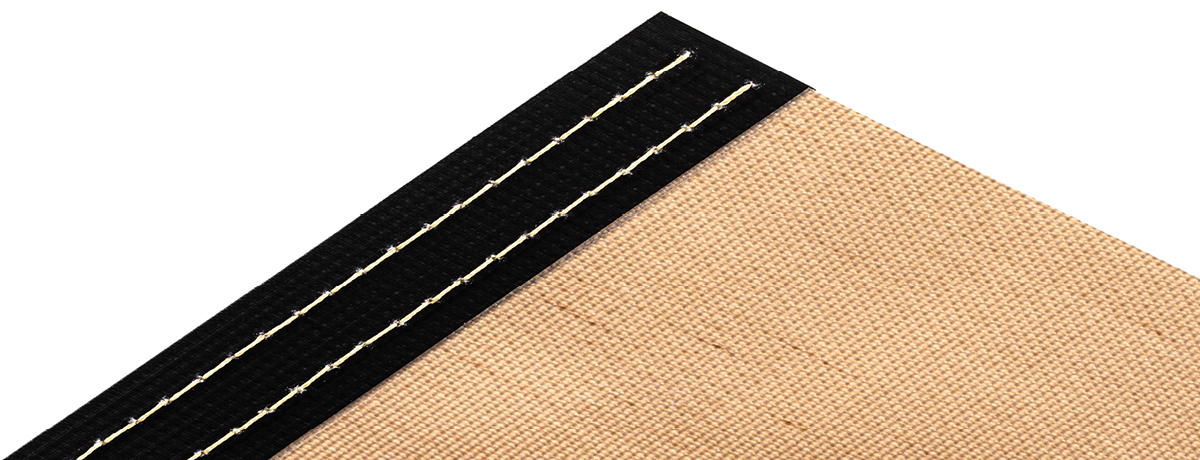 Sewn and sealed fabric edge reinforcement for open mesh conveyor belts